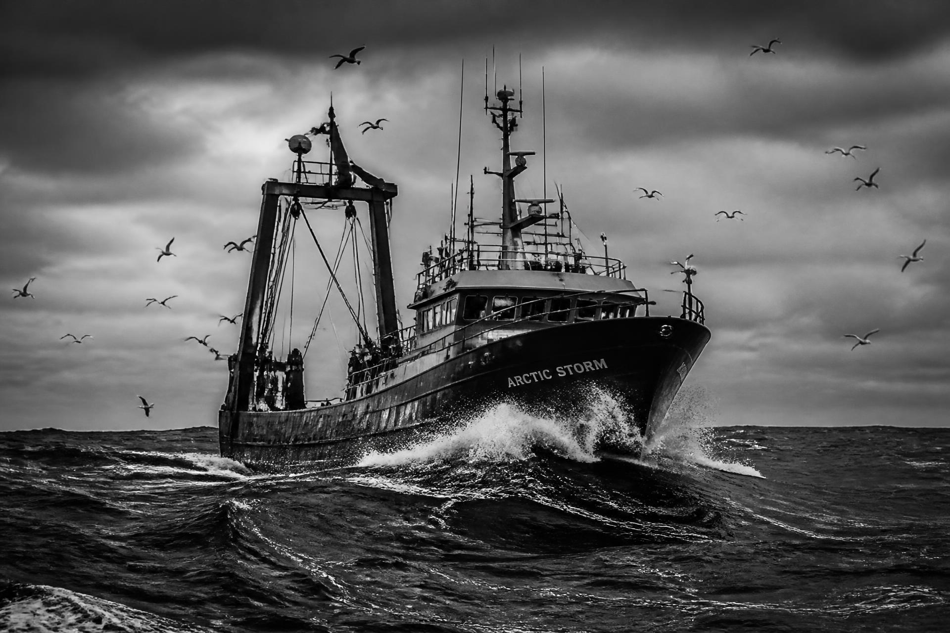Commercial fishing trawler working heavy seas