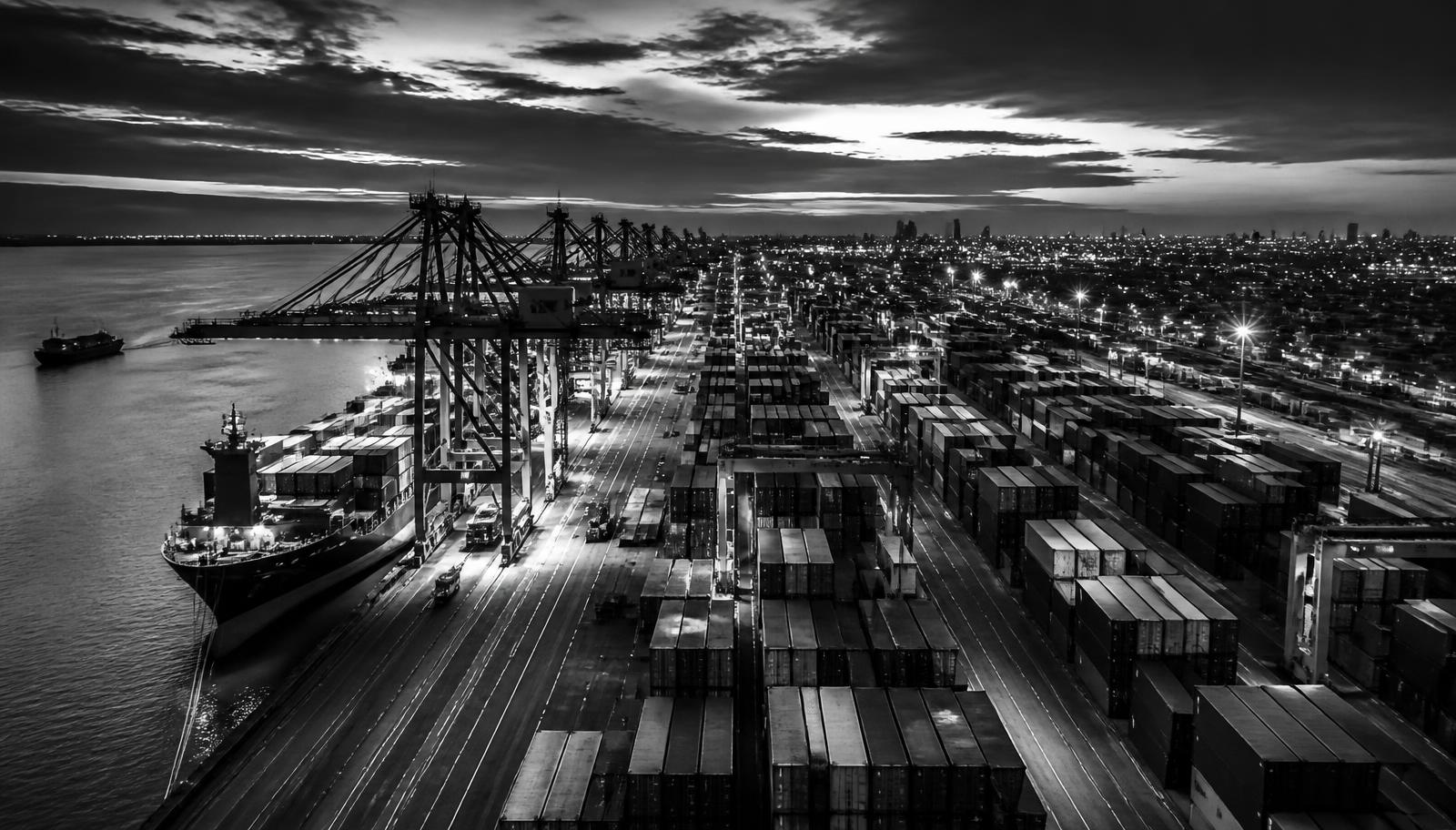Container terminal at dusk with vessels loading